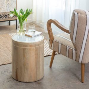 Vandana Aston Hexa – Moana Mango Wood & White Marble Side Table | Contemporary Accent Furniture The Vandana Aston Hexa – Moana Side Table is a refined blend of natural elegance, compact functionality, and contemporary design, created to elevate modern interiors with subtle sophistication. Designed as a versatile accent piece, this side table effortlessly complements living rooms, bedrooms, lounges, boutique hotels, and premium hospitality spaces. Crafted with a solid mango wood base and topped with genuine white marble, this table represents a harmonious contrast between warm organic textures and cool natural stone. Mango wood is highly regarded for its strength, durability, and eco-conscious sourcing, while white marble adds a timeless, luxurious appeal that enhances the overall aesthetic value of the piece. With its compact dimensions of 38 × 38 cm and a height of 46 cm, the Moana side table is ideal for use as a sofa side table, bedside table, accent stand, or decorative pedestal. Despite its small footprint, it offers excellent surface space for placing lamps, books, décor objects, or everyday essentials, making it both practical and stylish. Each marble top is naturally unique, featuring individual veining patterns, subtle tonal variations, and organic markings that make every piece one of a kind. These natural characteristics are a hallmark of authentic marble and add to the table’s exclusive, handcrafted charm. The clean lines and minimalist form allow this table to blend seamlessly with contemporary, modern, Scandinavian, Japandi, and luxury interiors. Its light color palette ensures compatibility with a wide range of furniture styles and color schemes. Delivered fully assembled, the Moana side table is designed for immediate use and long-term stability. The marble top simply rests securely on the wooden frame, allowing for easy placement and repositioning. Lightweight yet sturdy, it can be moved effortlessly from room to room, adapting to changing décor needs. The Vandana Aston Hexa – Moana Side Table is more than just a small furniture piece—it is a carefully designed accent that adds balance, elegance, and refinement to any space. Perfect for both residential and export markets, it meets the expectations of customers seeking premium materials, timeless design, and everyday functionality.